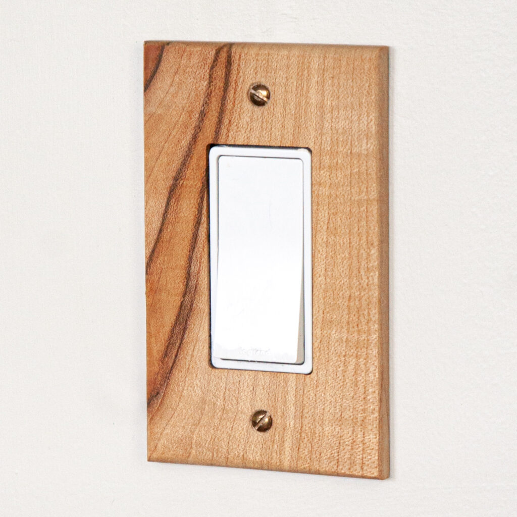 electrical rocker switch covered with a figured maple rocker switch cover made by Virgin Timber Lumber It was finished with tung oil