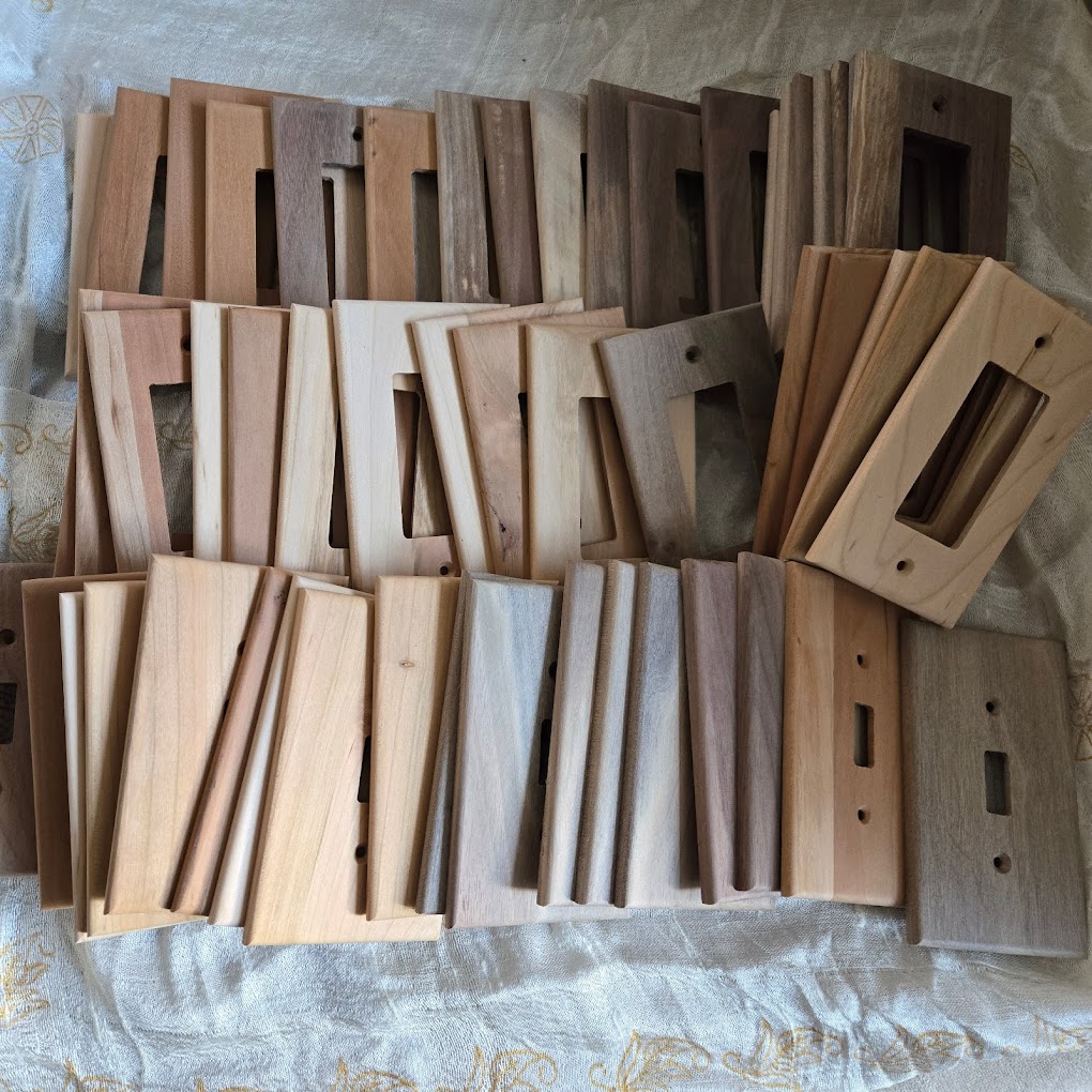 a box full of "seconds" wood wall plates with minor defects